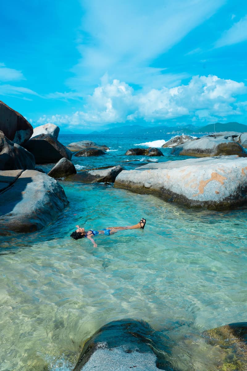 a person lying on her back in a body of water