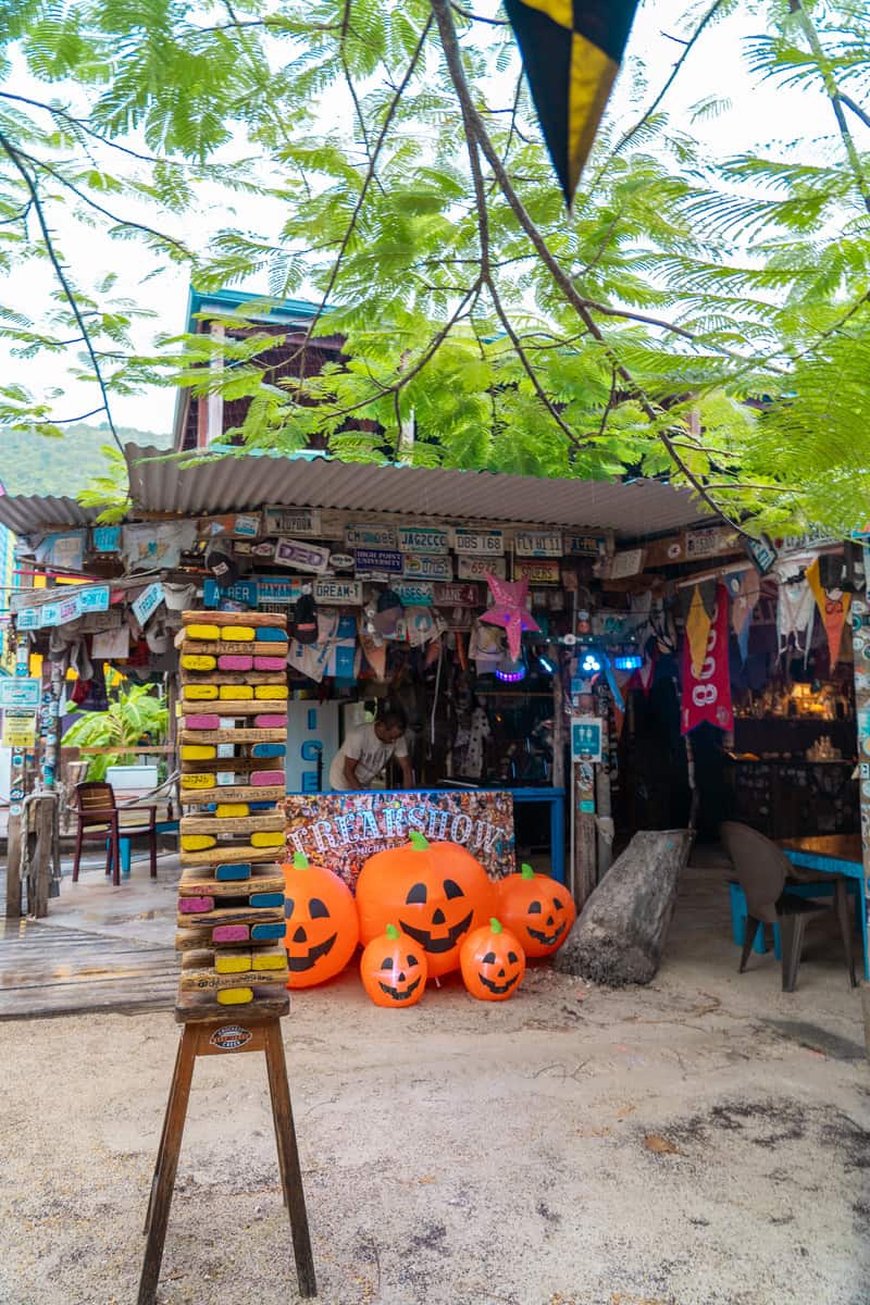 a store with pumpkins and flags