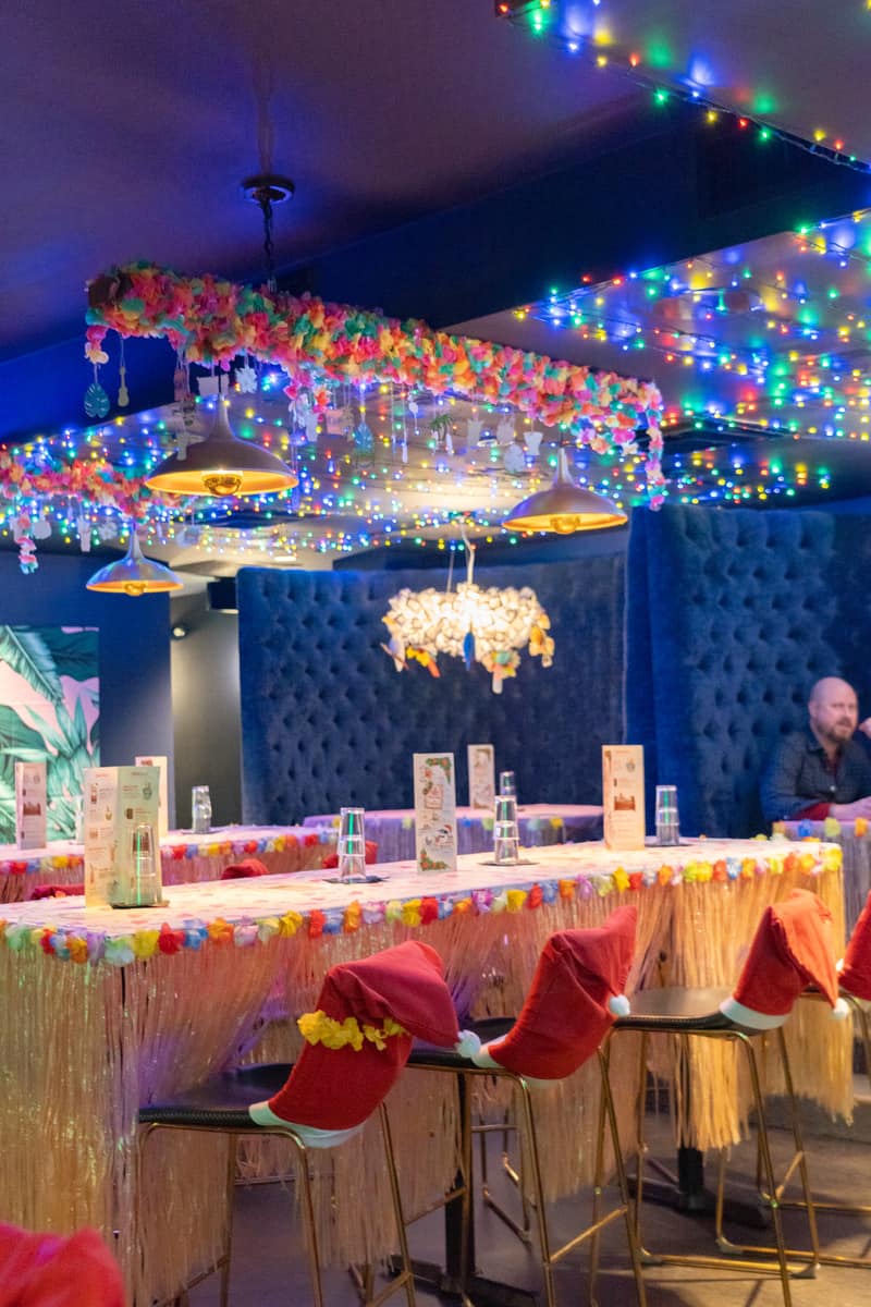 A vibrant bar with colorful lights and tables, perfect for a fun night out with friends.
