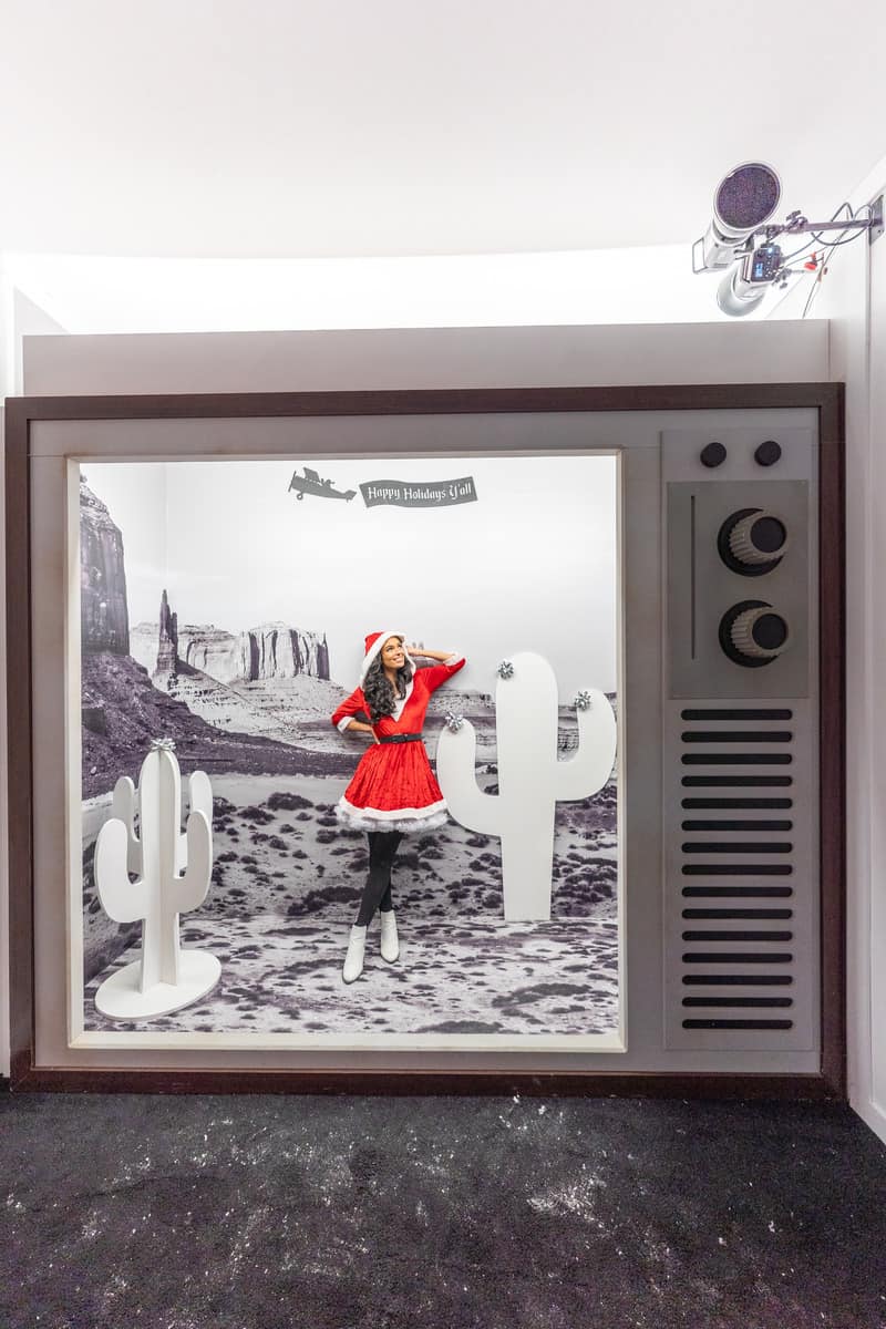 A woman in a Santa costume on a vintage telvesion photo op