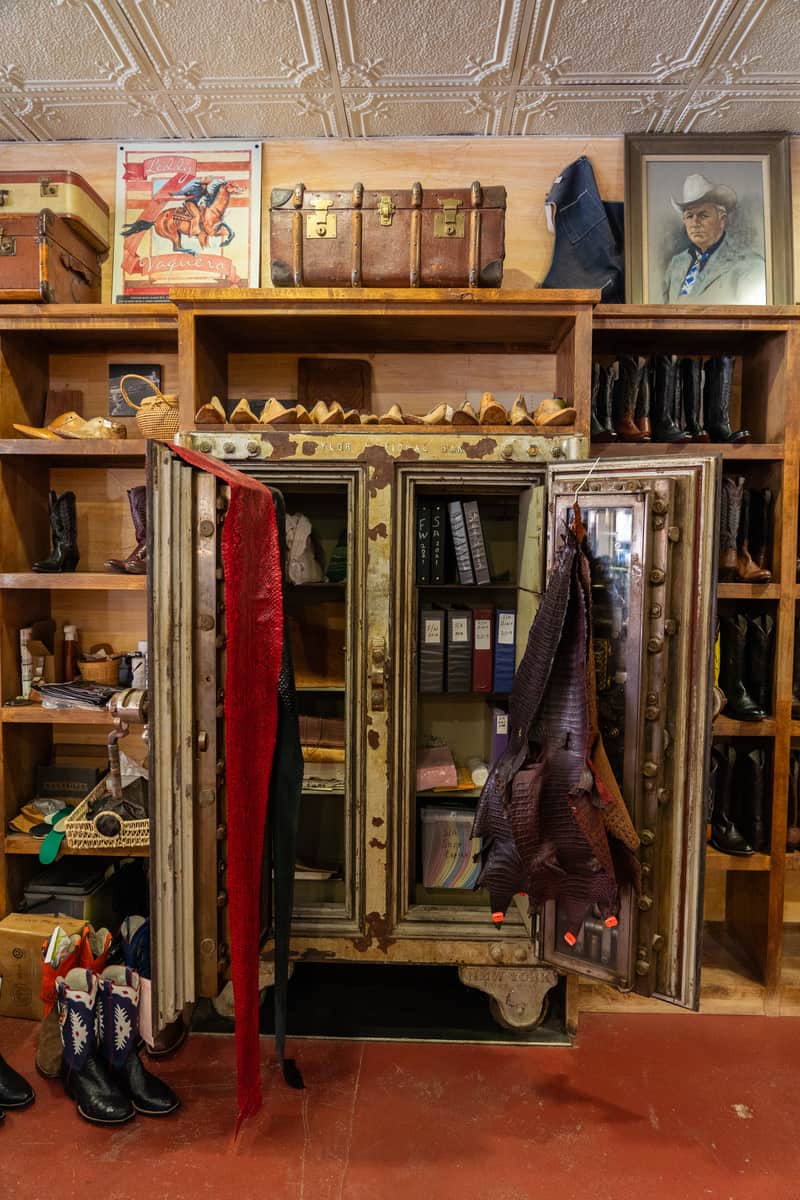 Boots and Western decor on display with a wardrobe in the center of the wall.