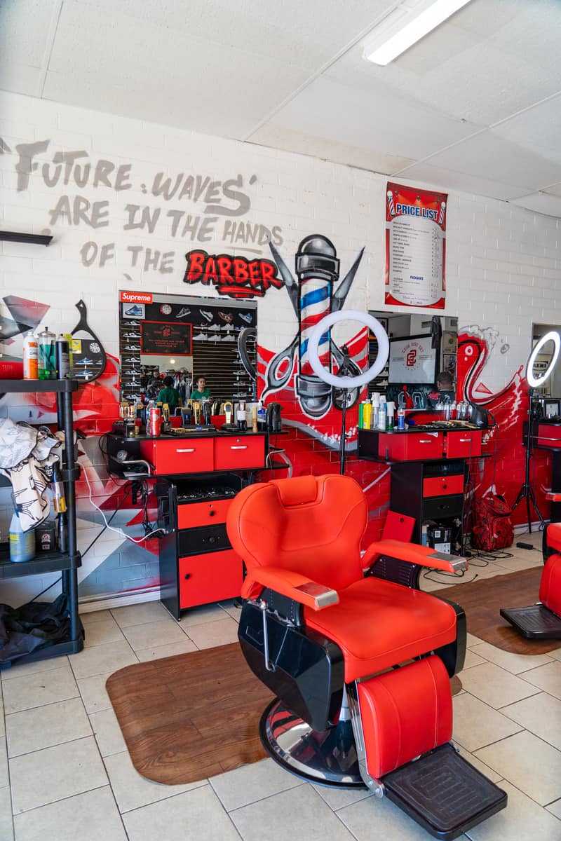 Barbershop set-up with bright red furniture and barber chairs
