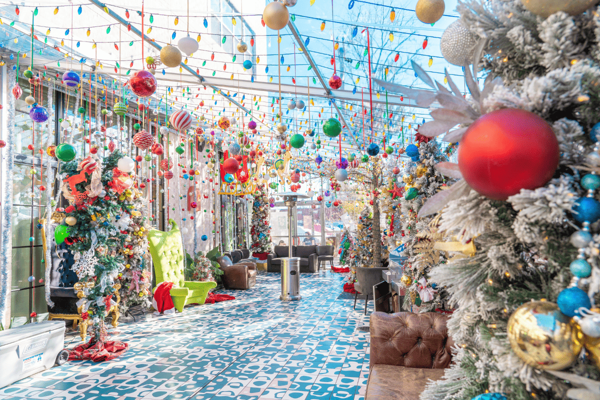 A festive hallway full of beautiful christmas decoration and christmas trees.
