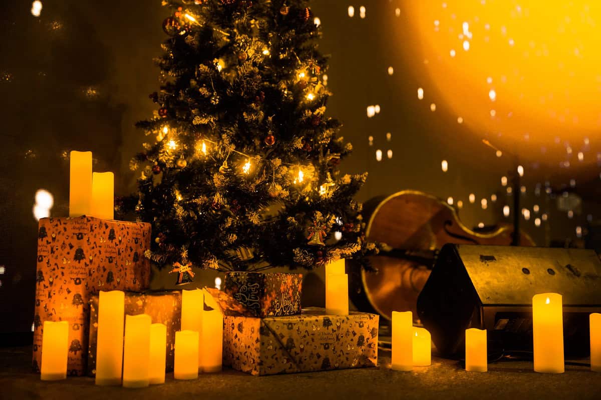 Christmas tree adorned with candles and gifts