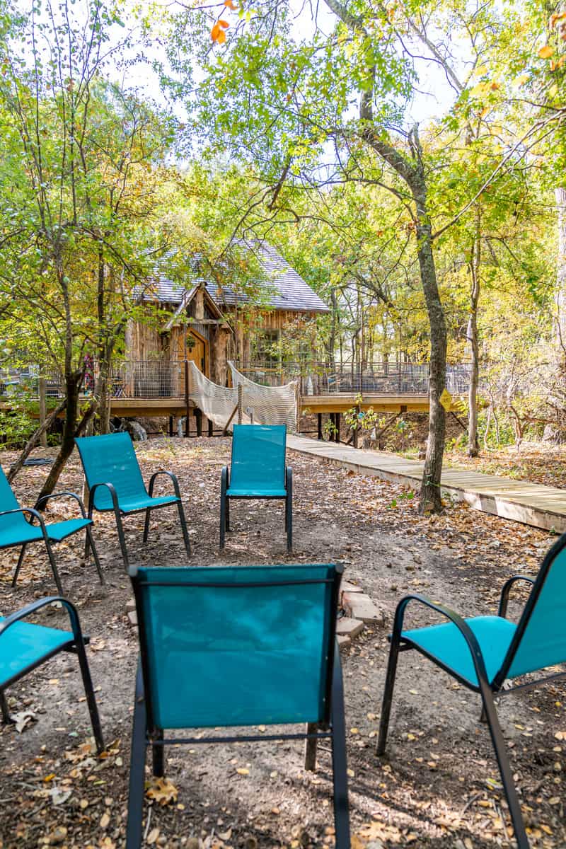 inground fire pit with blue chairs