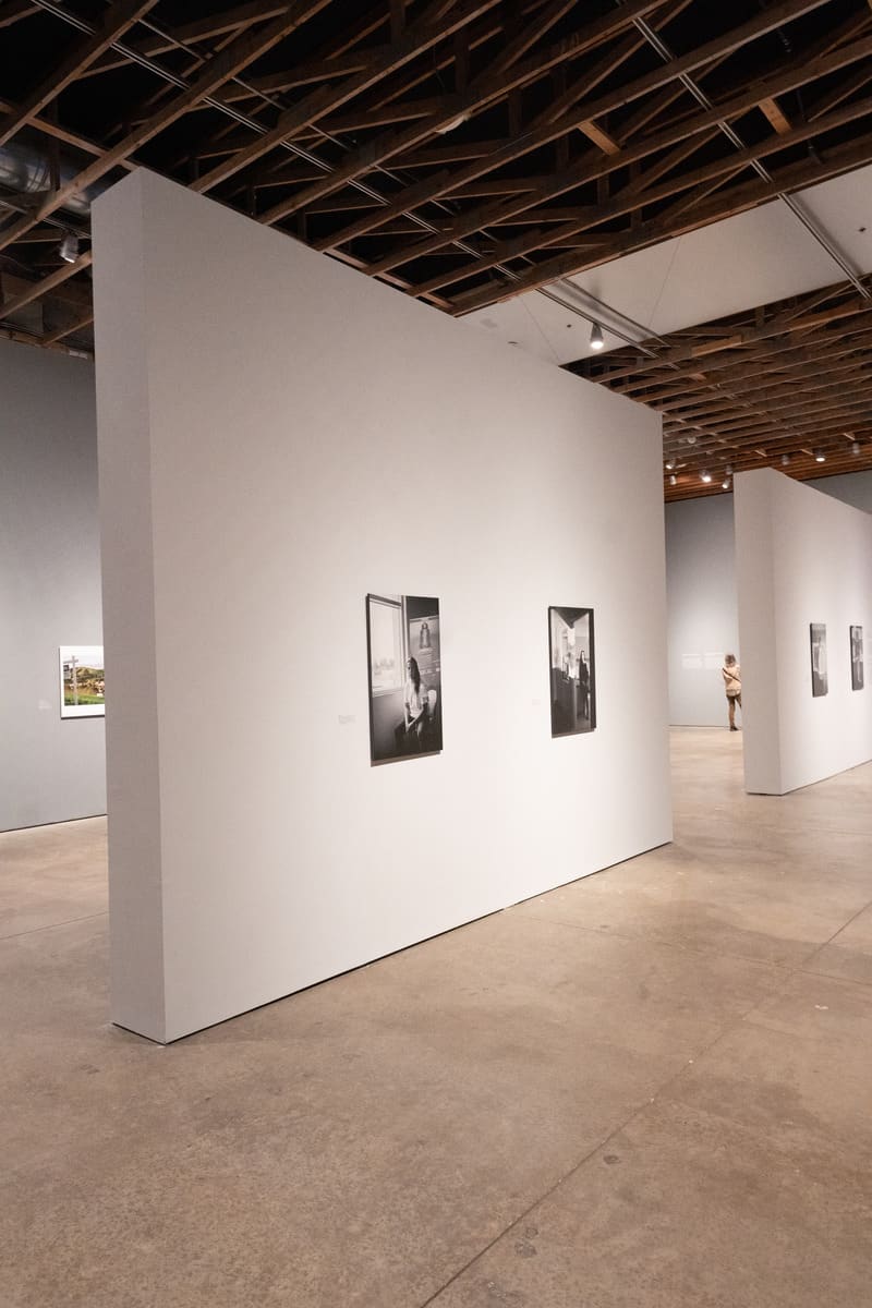 White gallery walls with black-and-white photographs on display