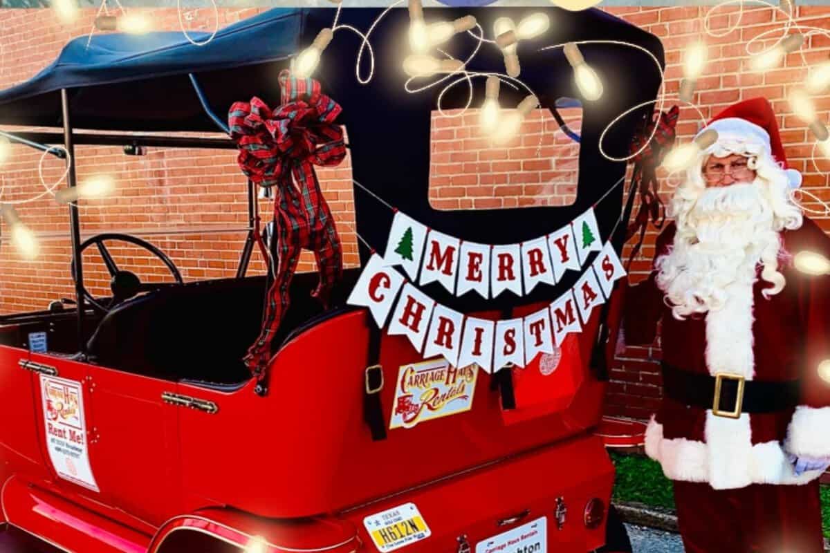 A red holiday-themed carriage with a "Merry Christmas" banner