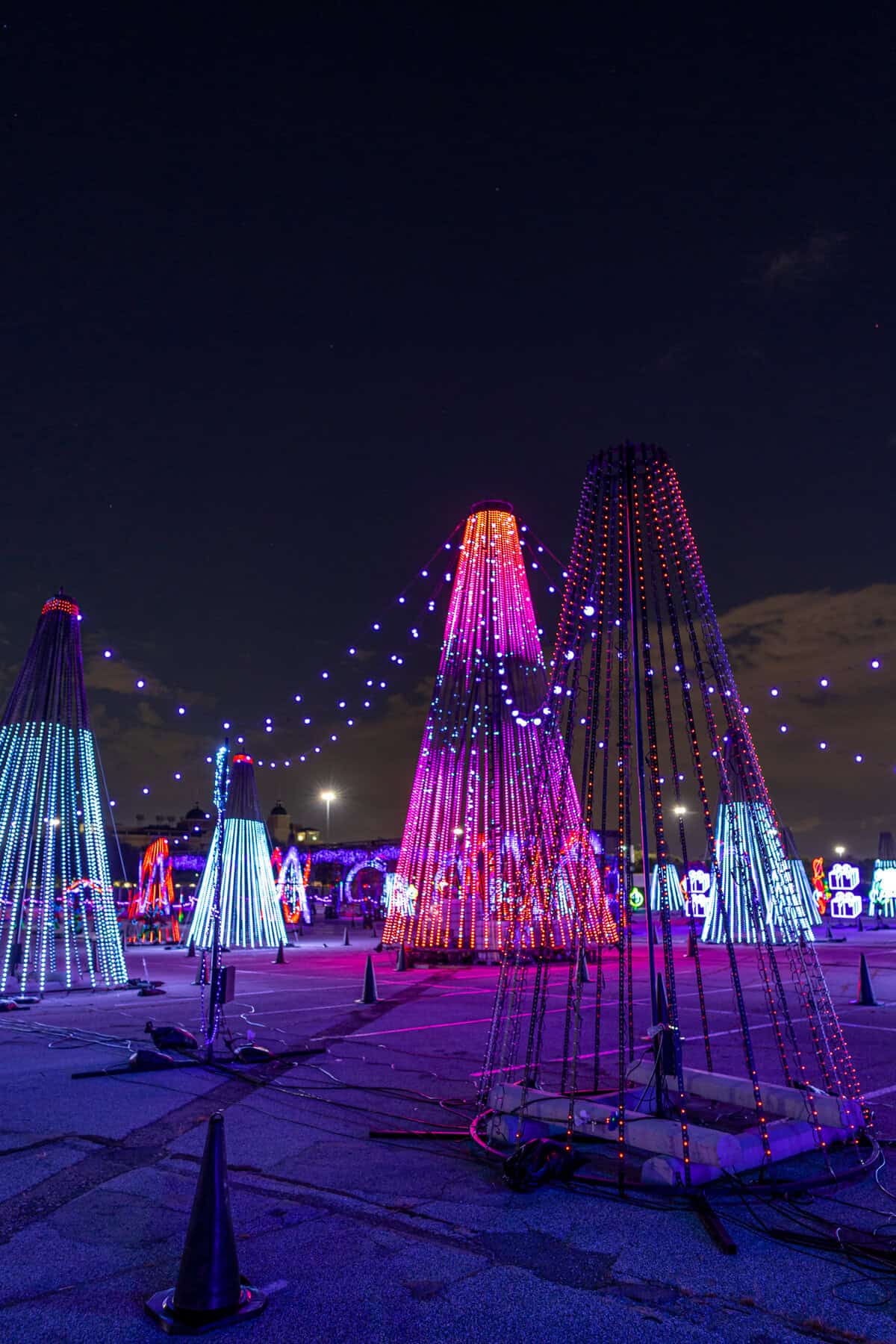 Illuminated colorful cone-shaped light installations at a night event