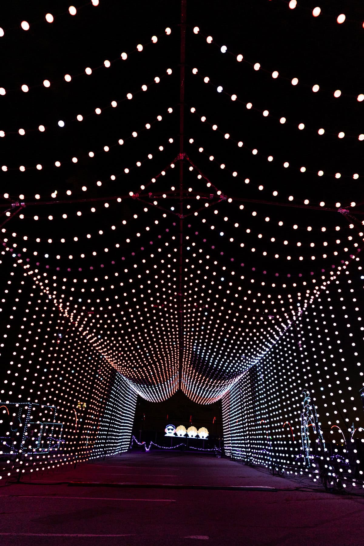 A tunnel of white lights stretching into the distance at night.