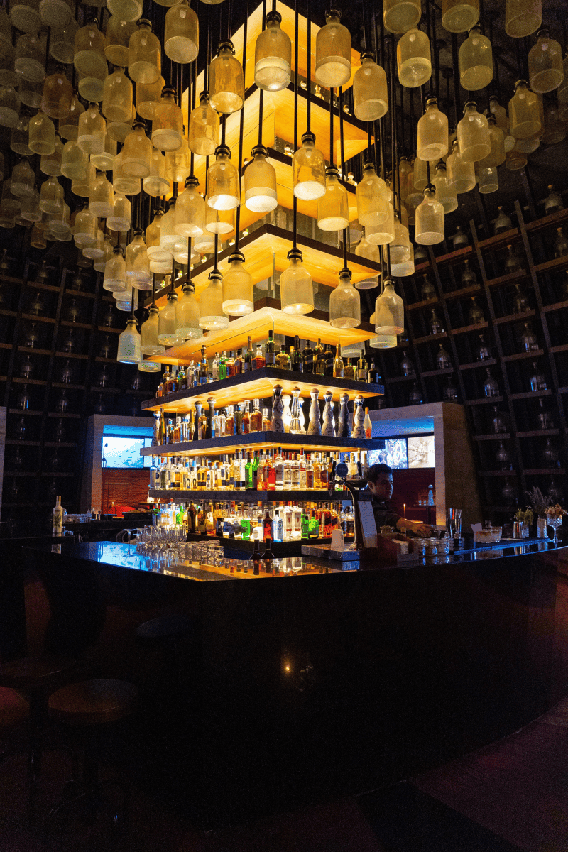  A lively bar setting filled with numerous drinks and dazzling lights.