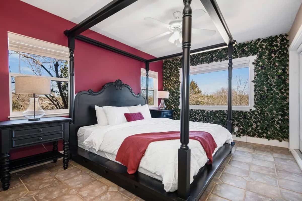 A luxurious bedroom with a four-poster dark wood bed