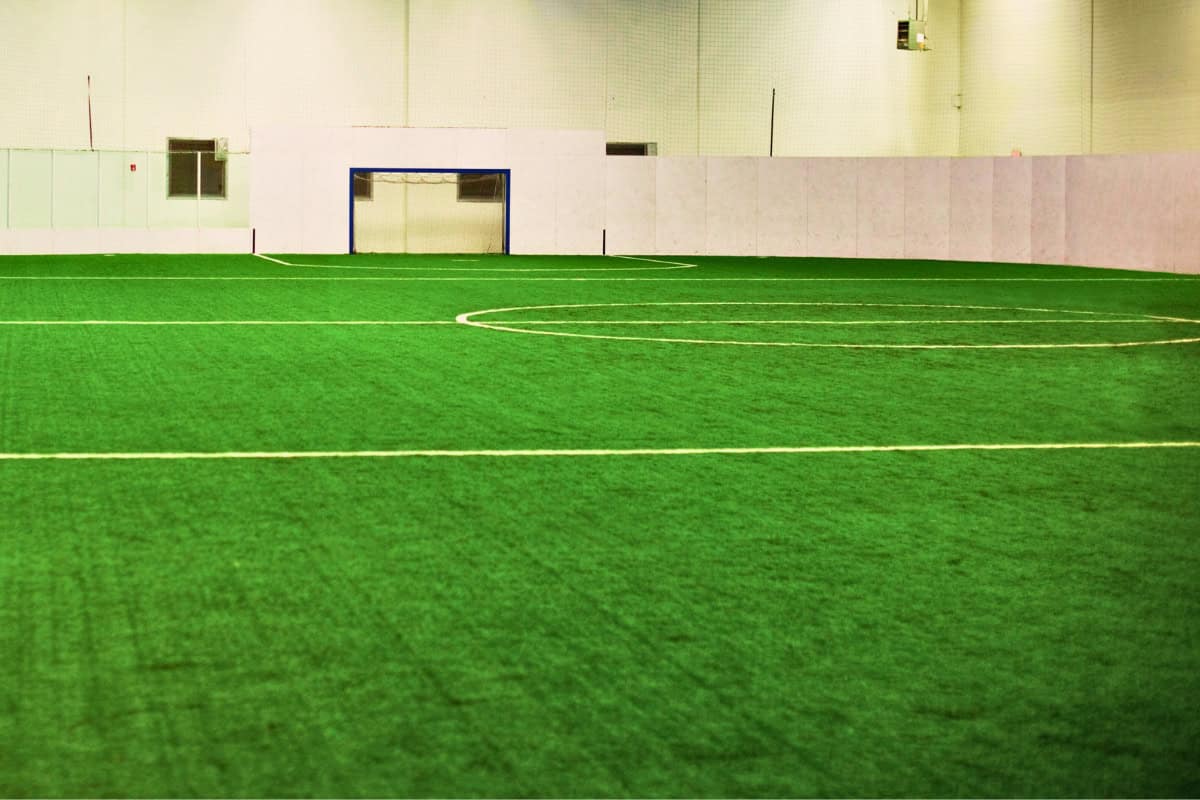 A soccer field with a goal in the middle.