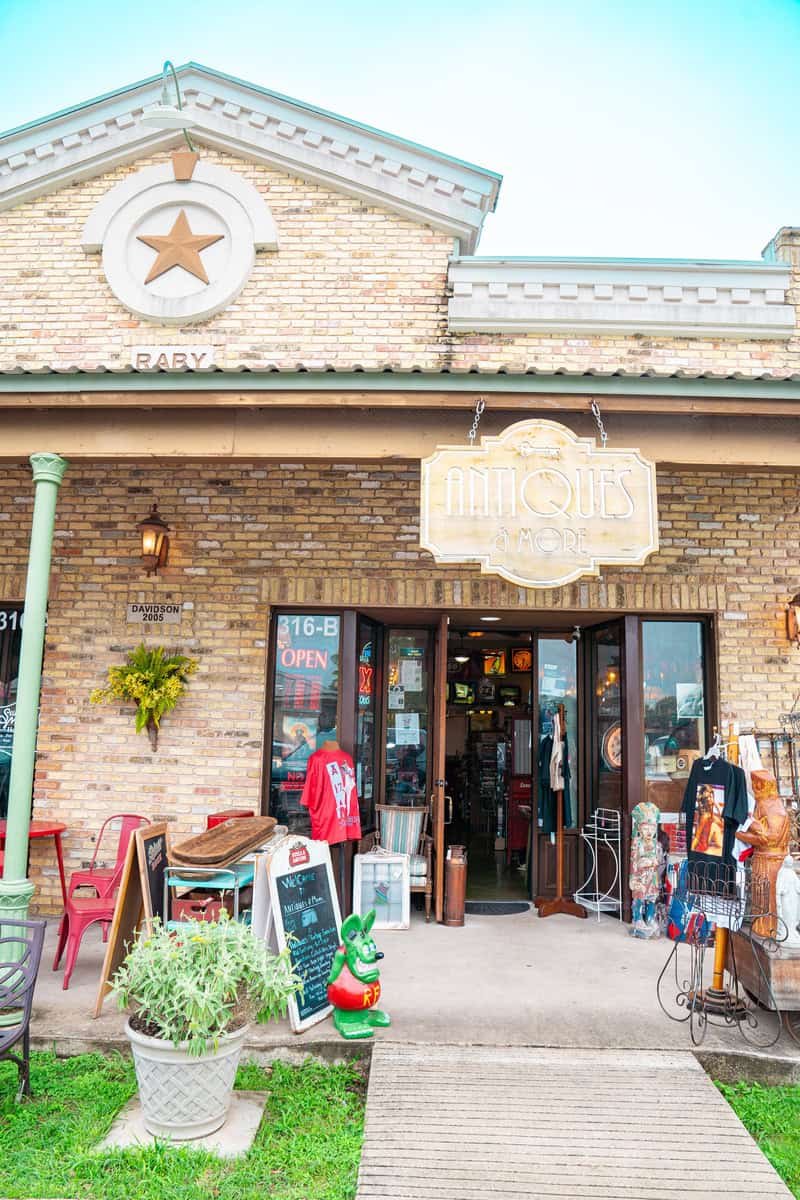 a store front with a sign and signs