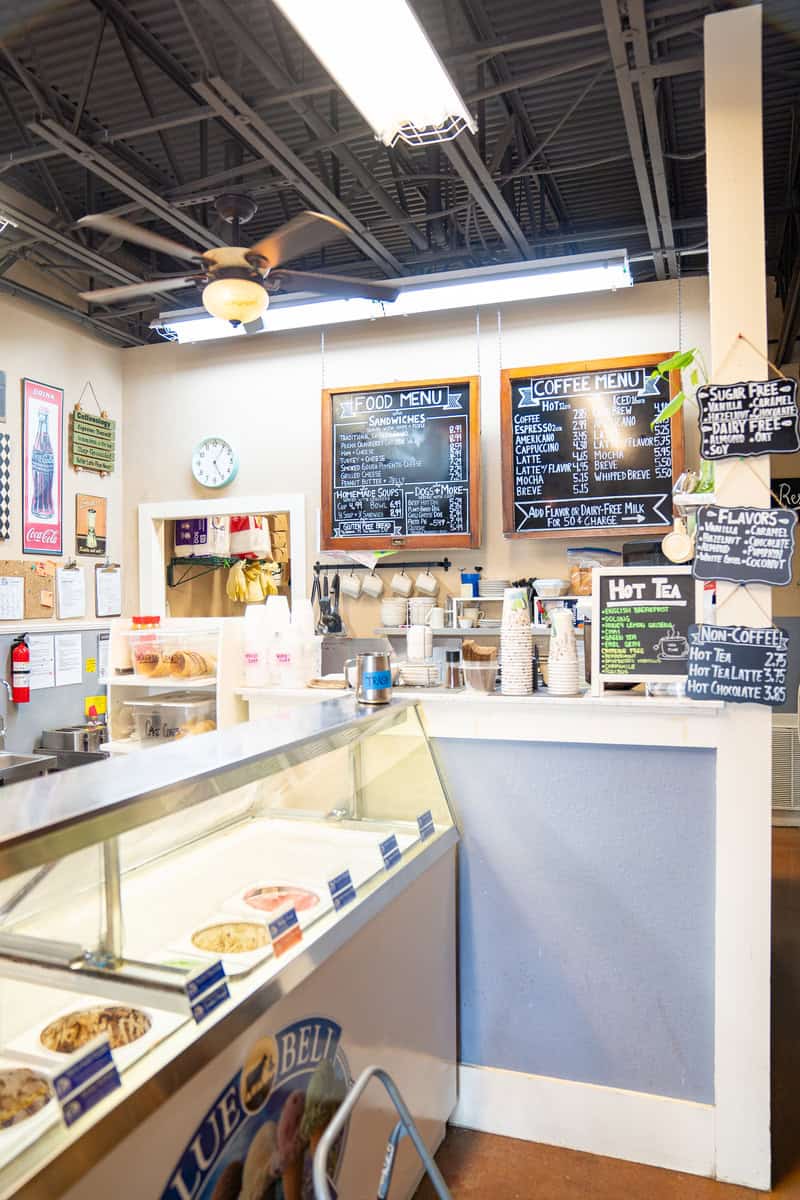 a coffee shop with a counter and menu