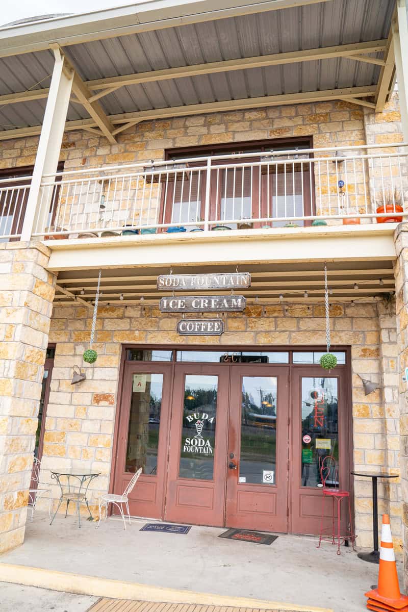 a building with a balcony and a sign