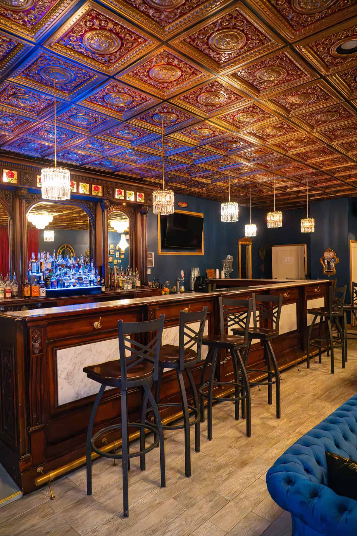 a bar with a mirror and bar stools