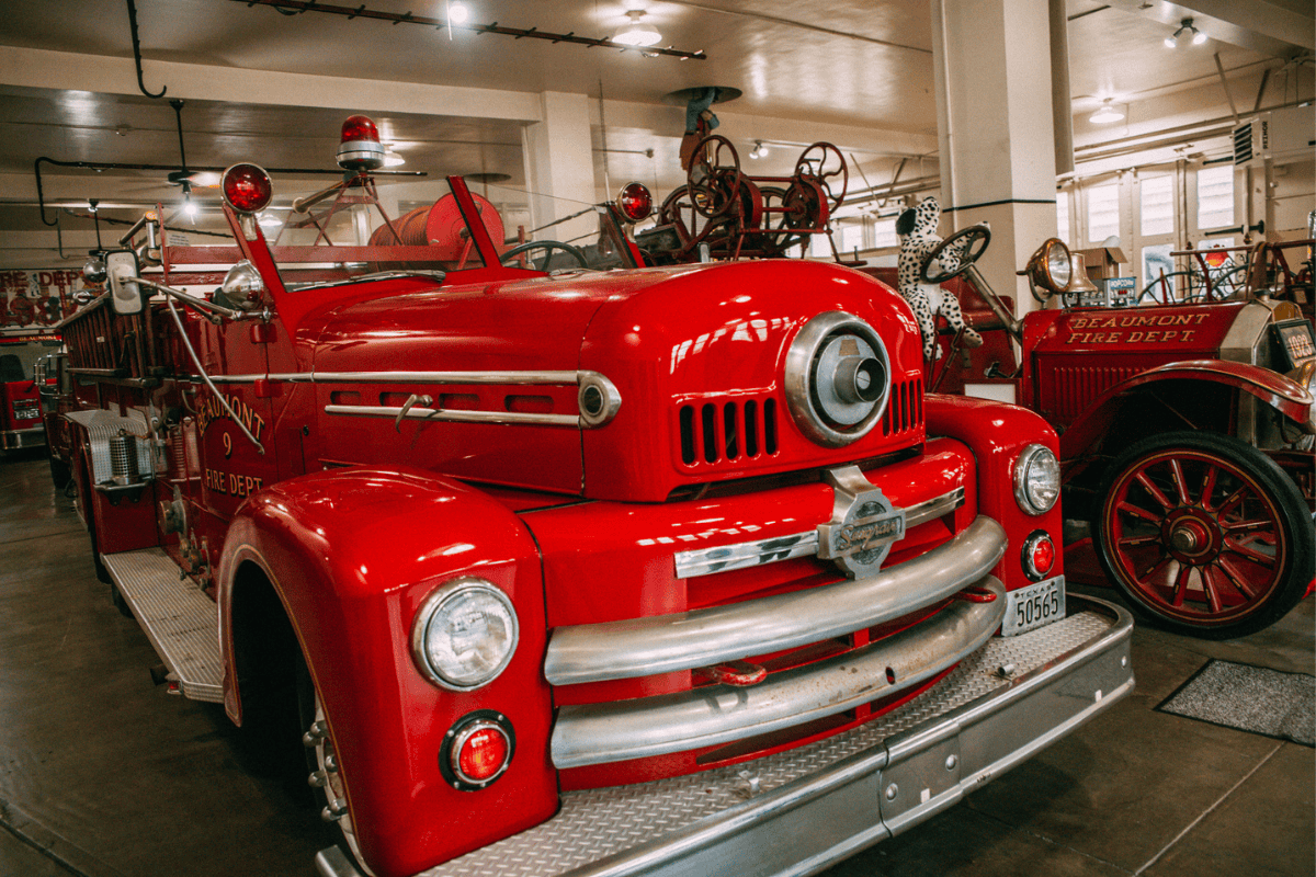 Bright red fire truck with sirens and ladder, symbol of safety.