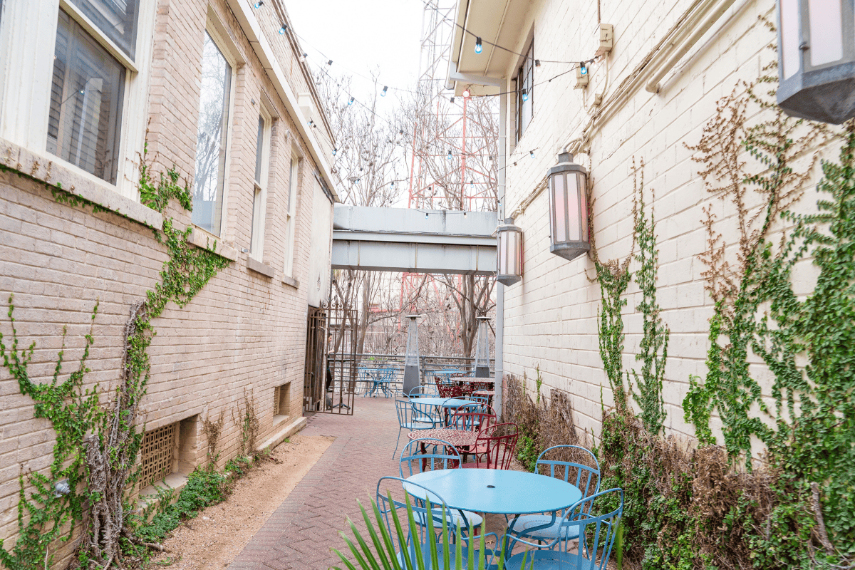 a patio area with tables and chairs