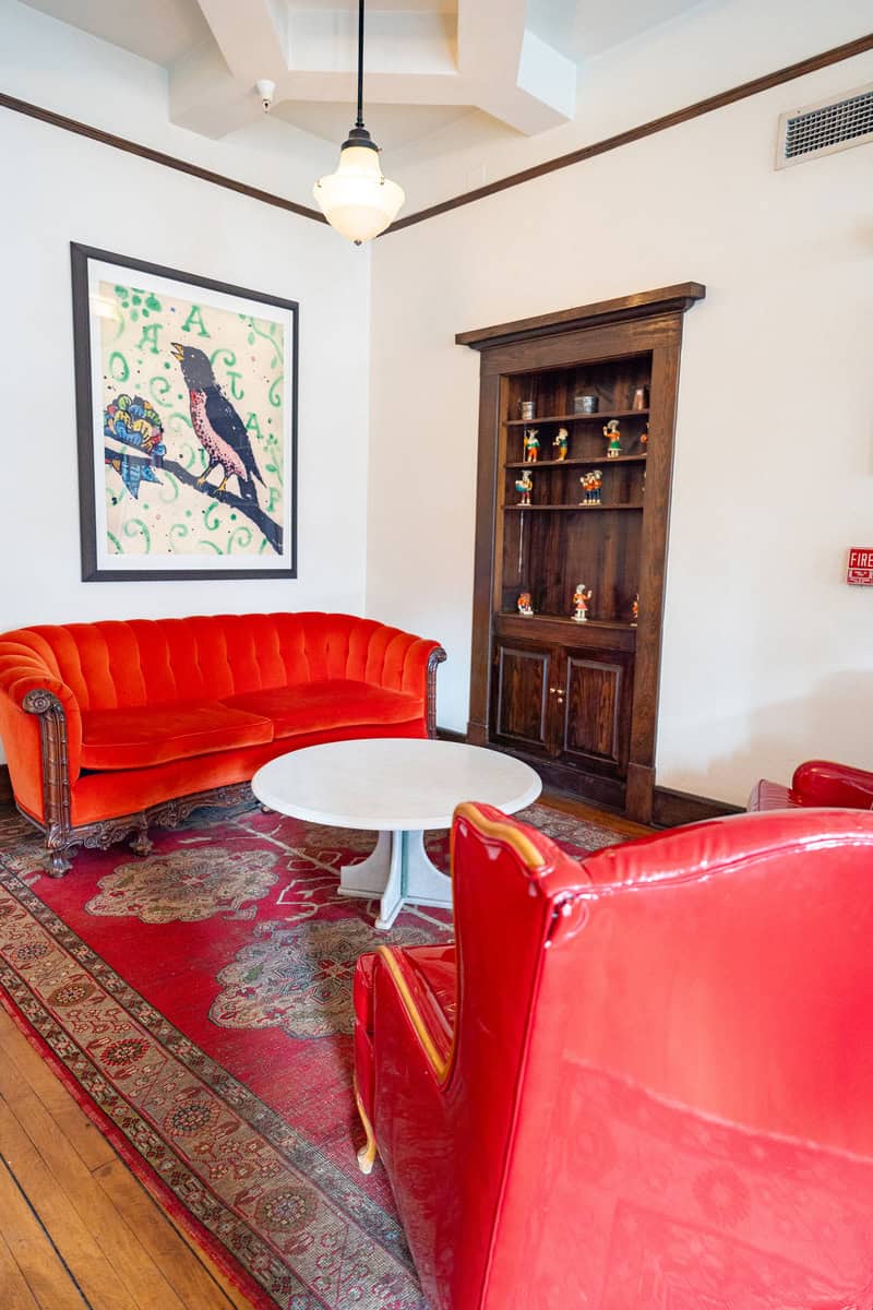 a room with red couch and red chair