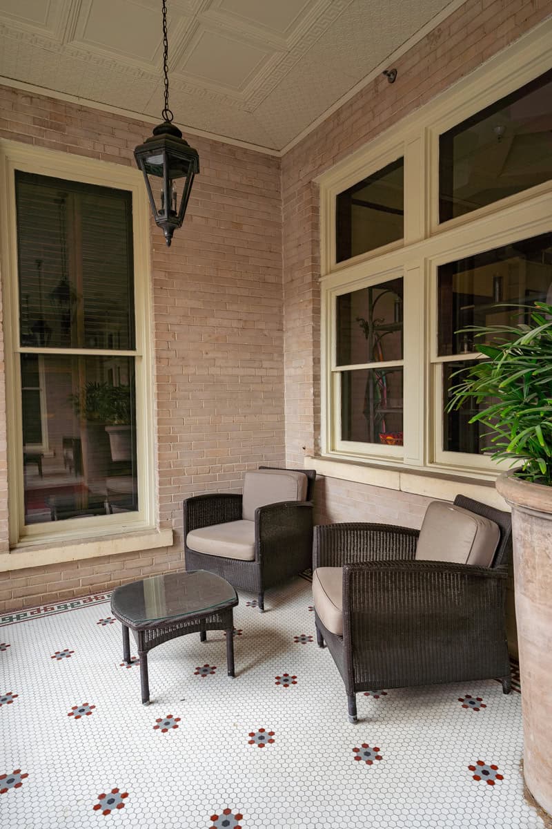 a patio with chairs and a table