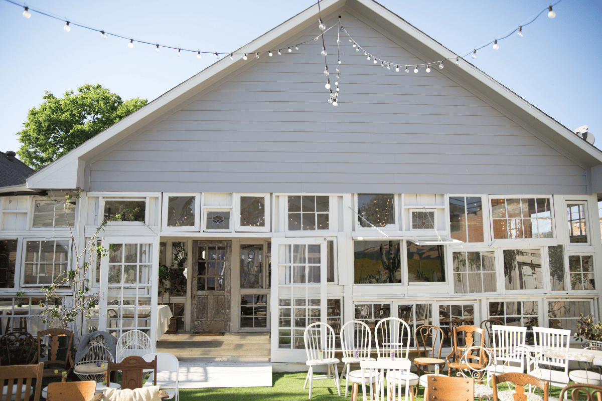 A quaint outdoor event space featuring a large gray building