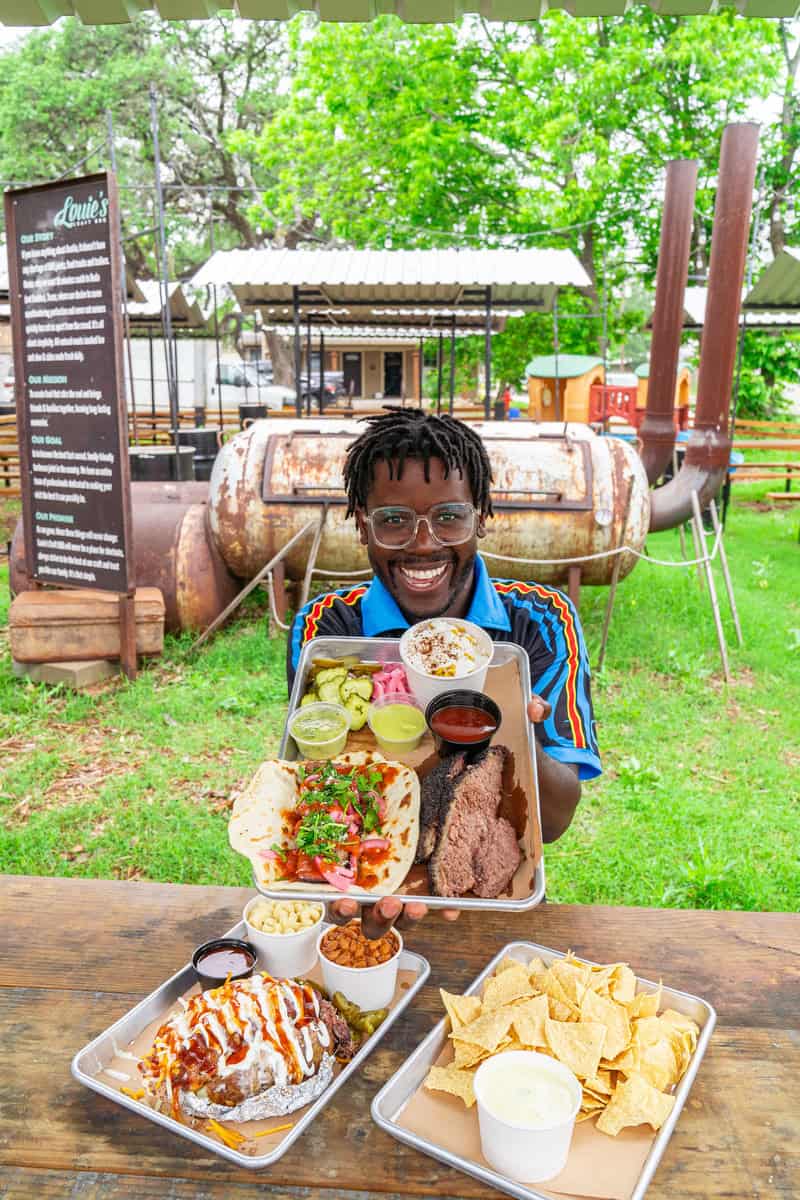 a man holding a tray of food