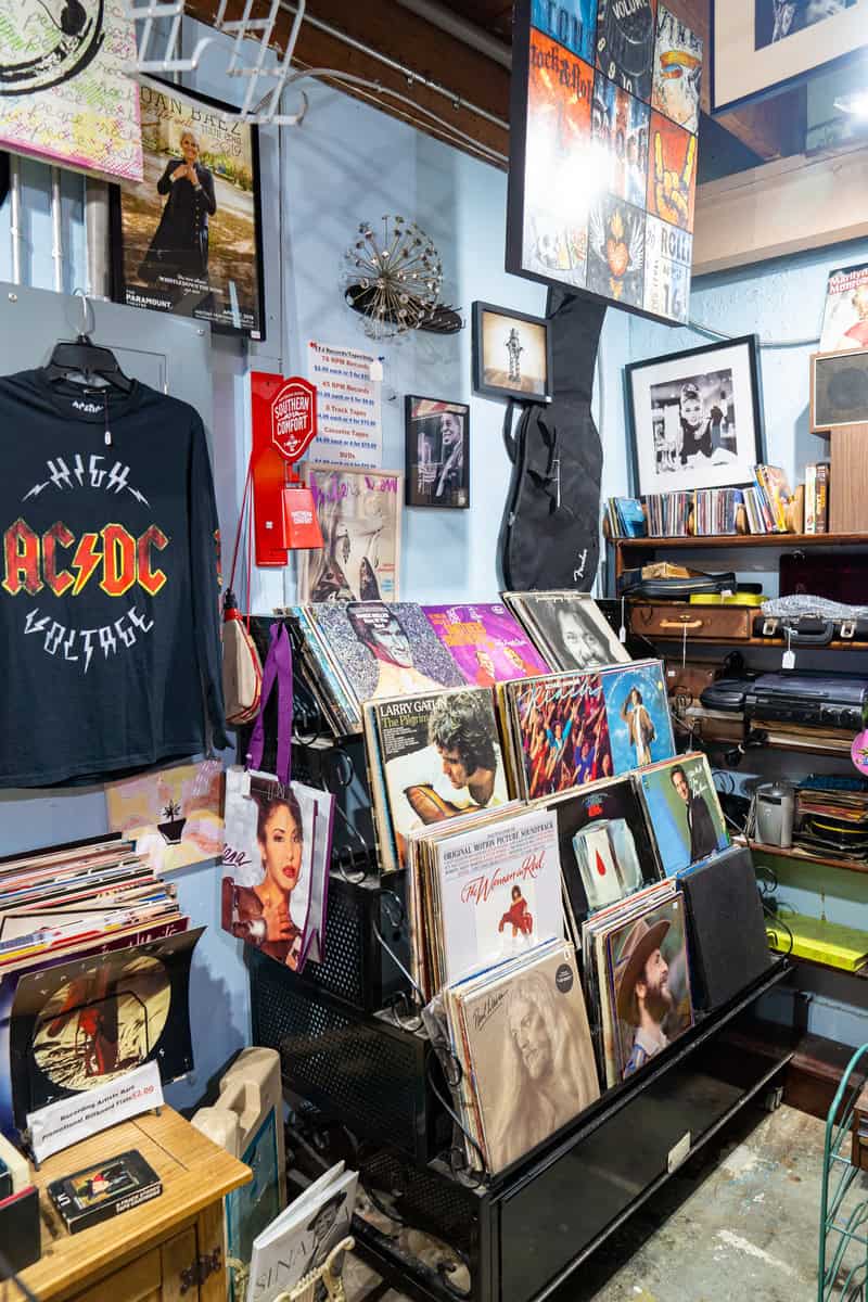 a room with a guitar and music items