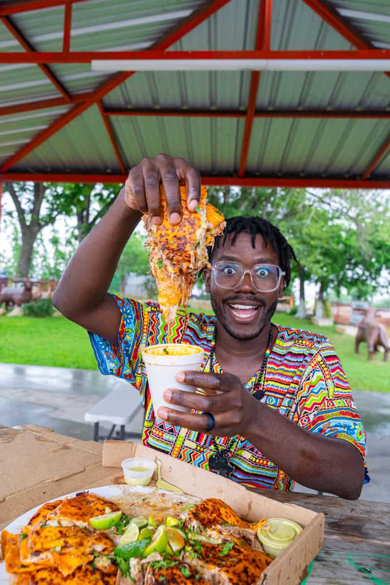 a man holding a cup of food