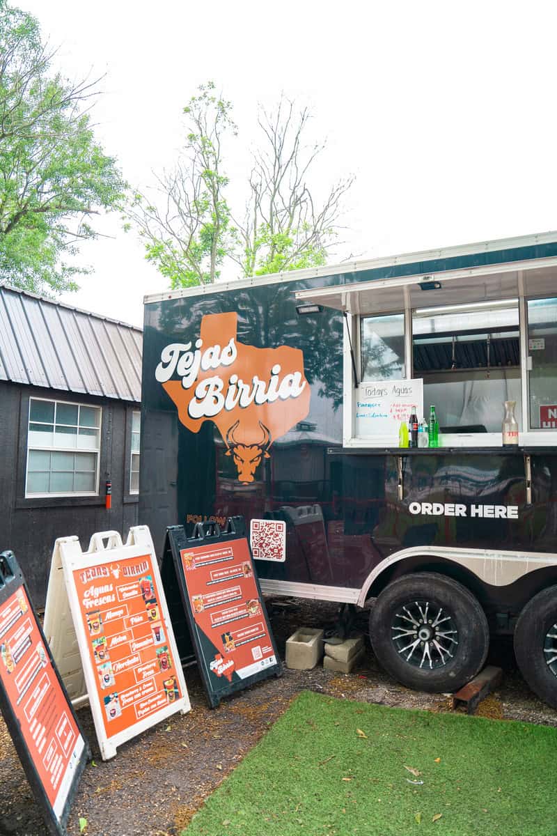 a food truck with signs and a sign on the side