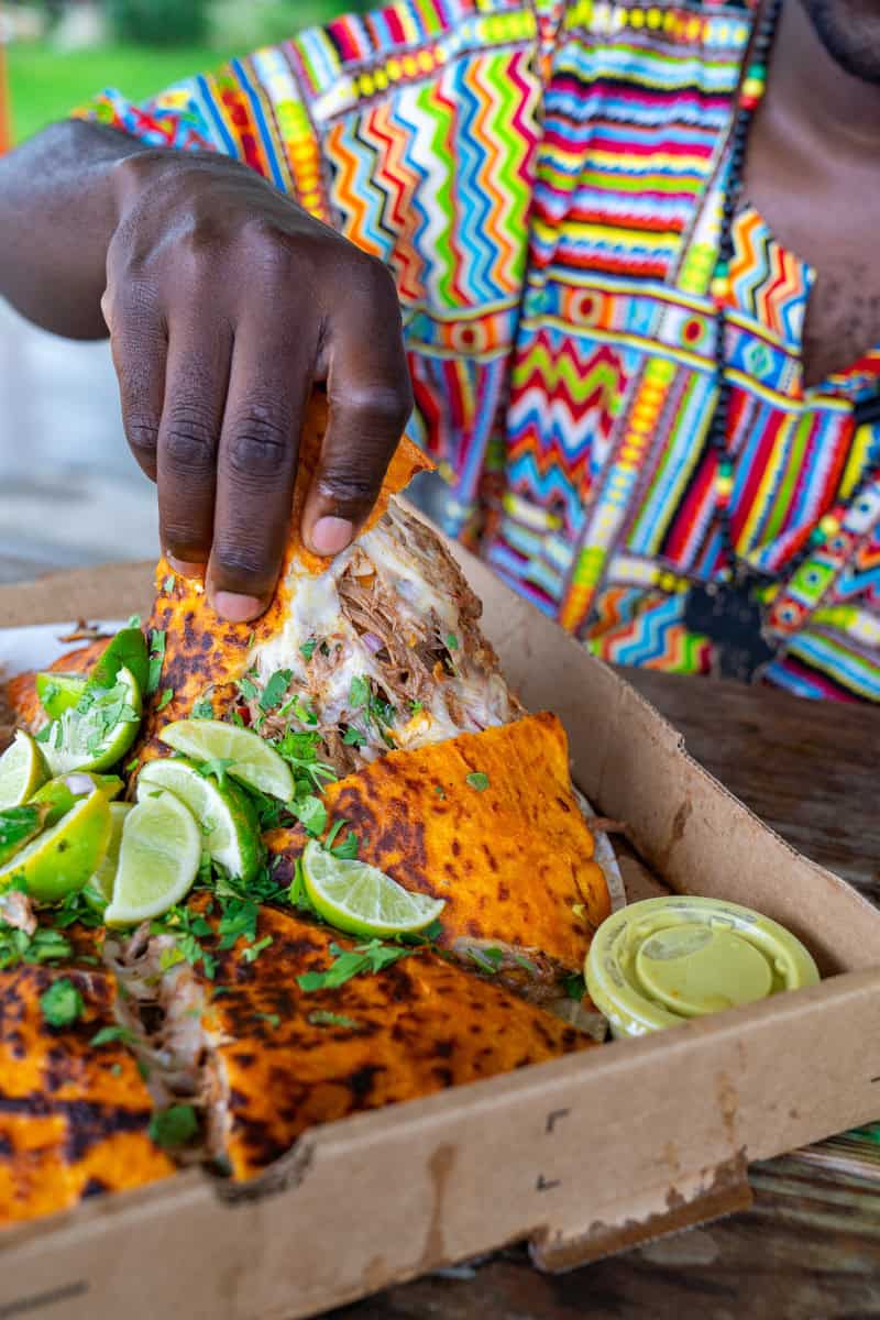 a person holding a piece of food