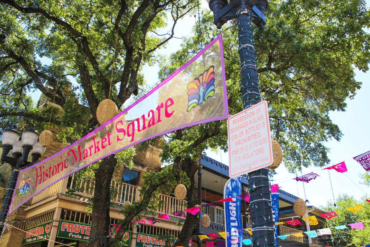 A street with a street light and a banner hanging from a pole.