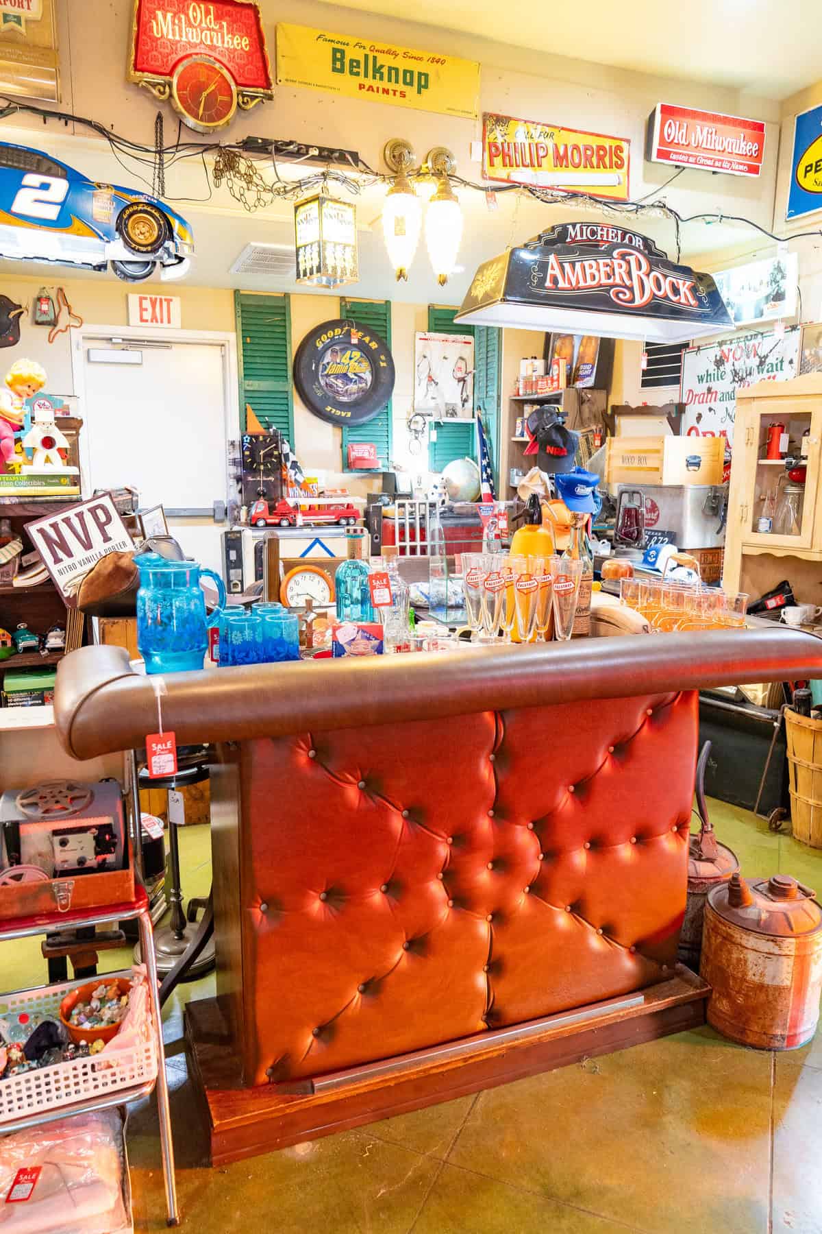 a room with a bar and a red leather couch