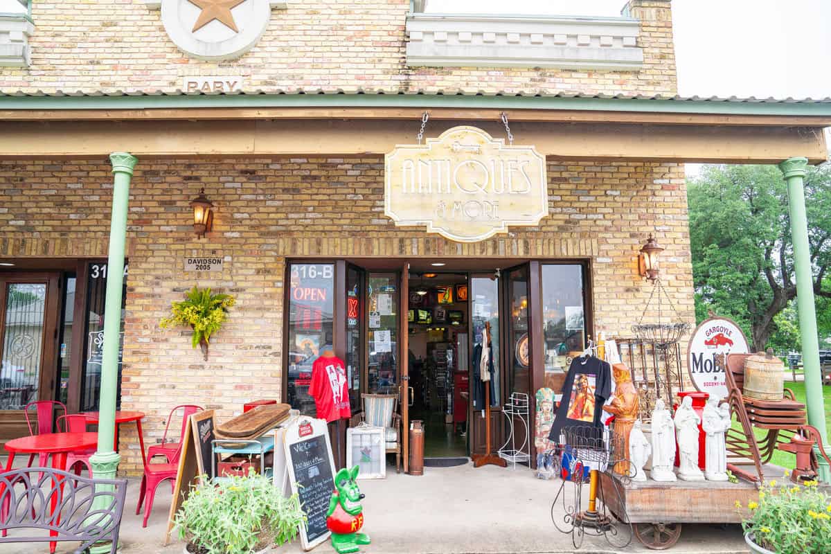 a store front with a sign and signs