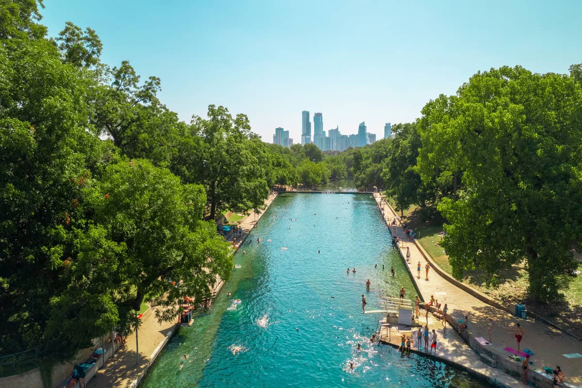 a body of water with people swimming in it