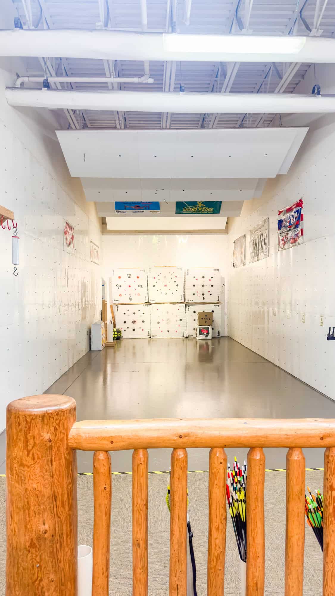 a room with white walls and a wooden railing