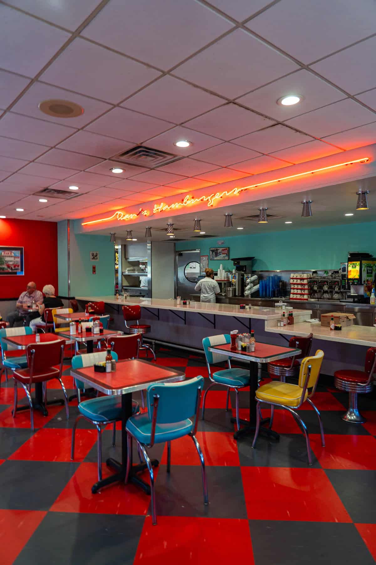 a diner with red and blue chairs and tables