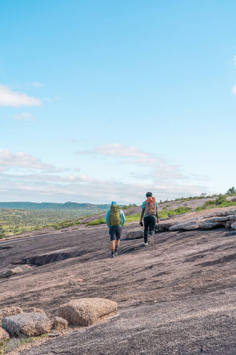 Two men hiking on an enchanted rock - free date ideas in san antonio