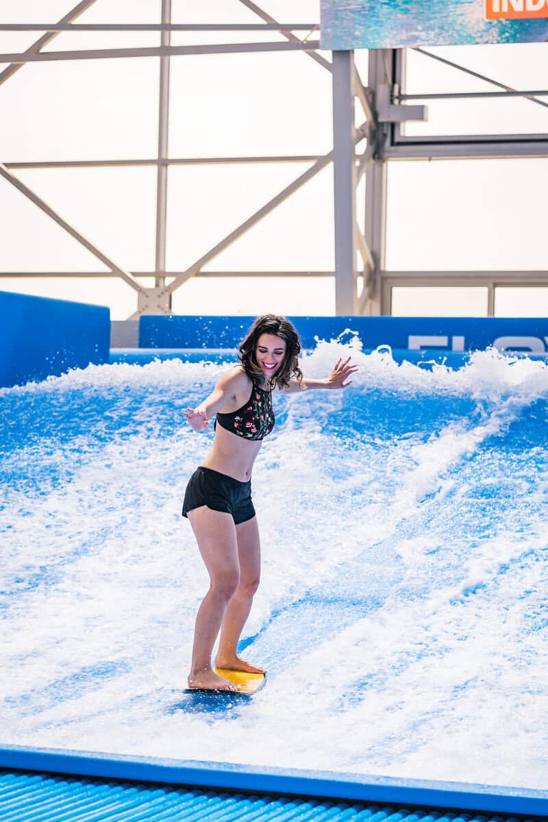 Woman surfing a wave on a surfboard.