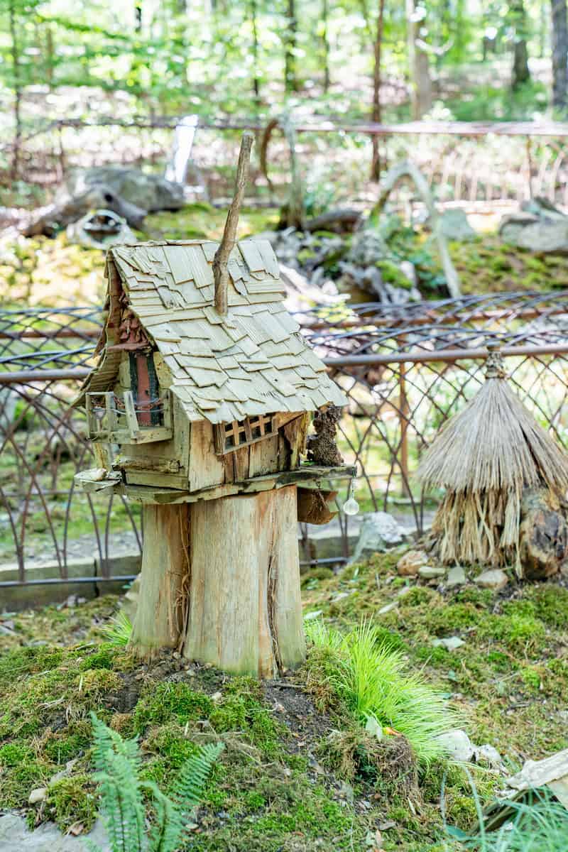 A mini wooden house with a charming roof.