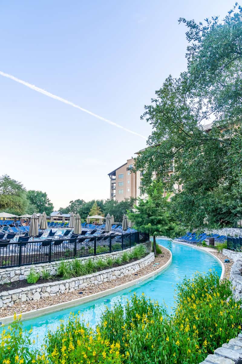 a pool with chairs and umbrellas