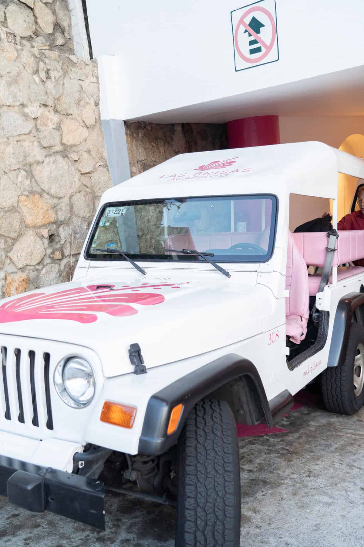 a woman in a pink vehicle