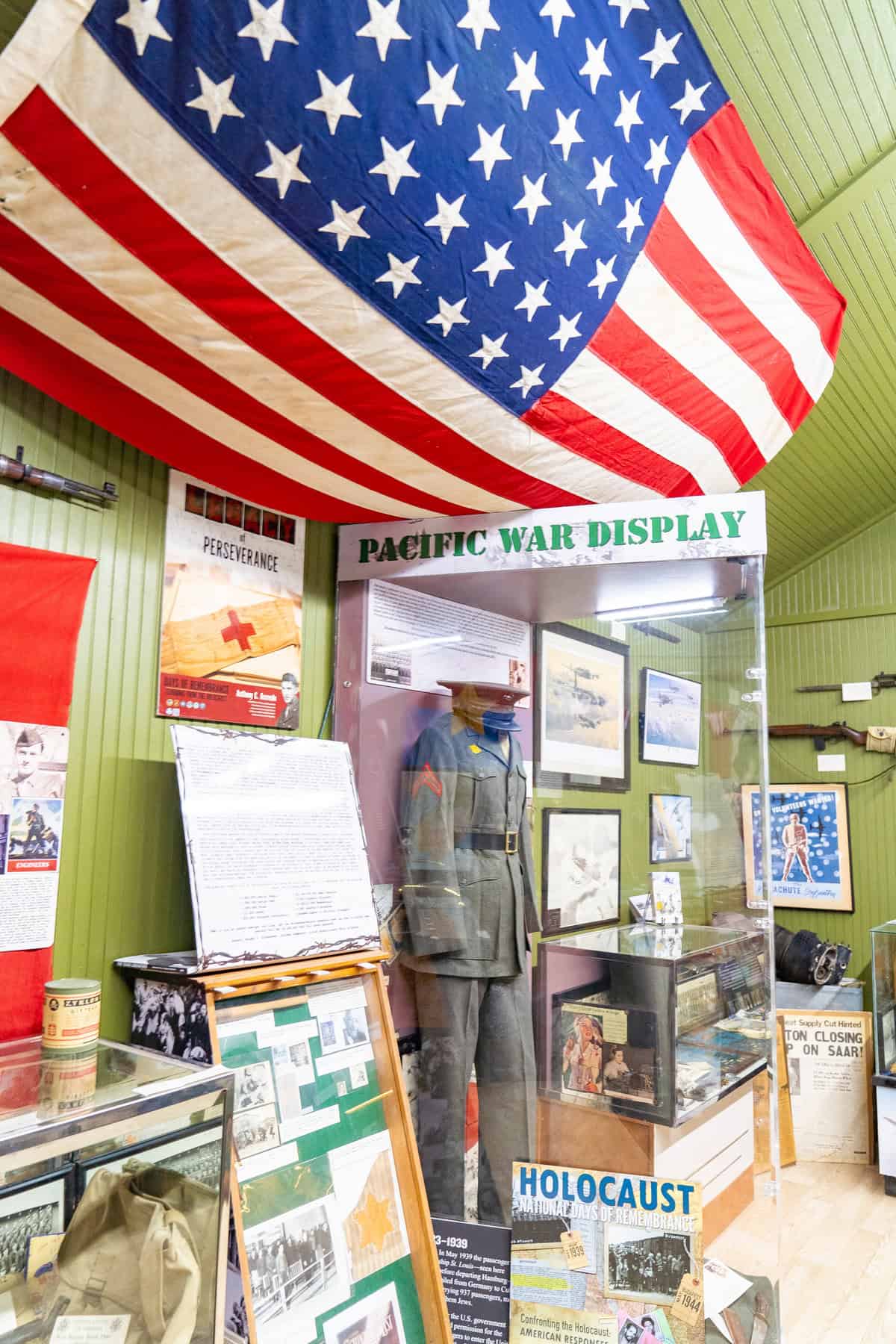 a display case with a uniform and a flag