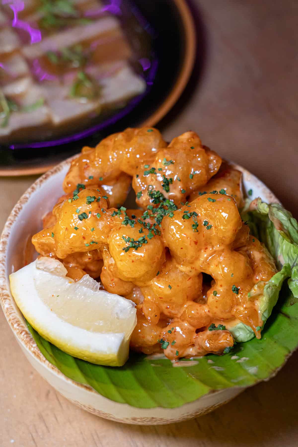 a bowl of food with a lemon wedge