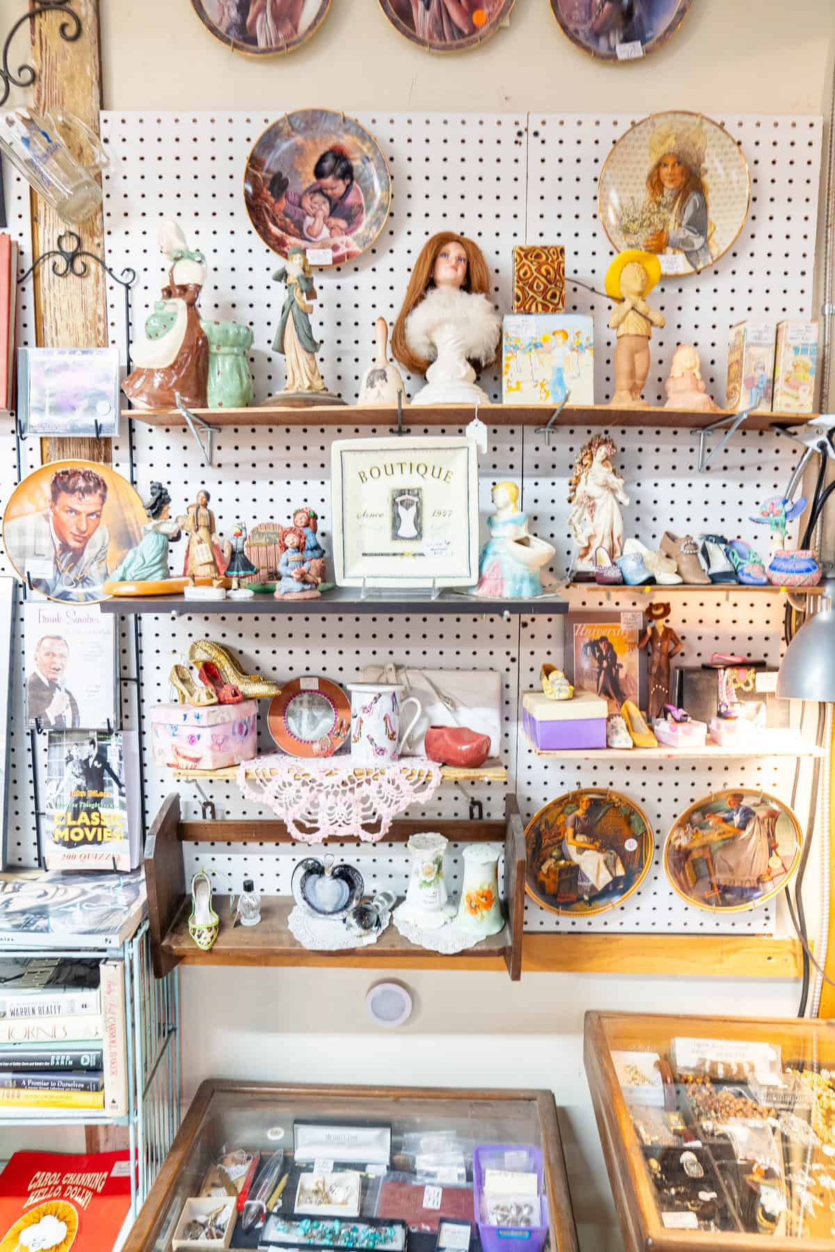 a shelf with figurines and other objects on it