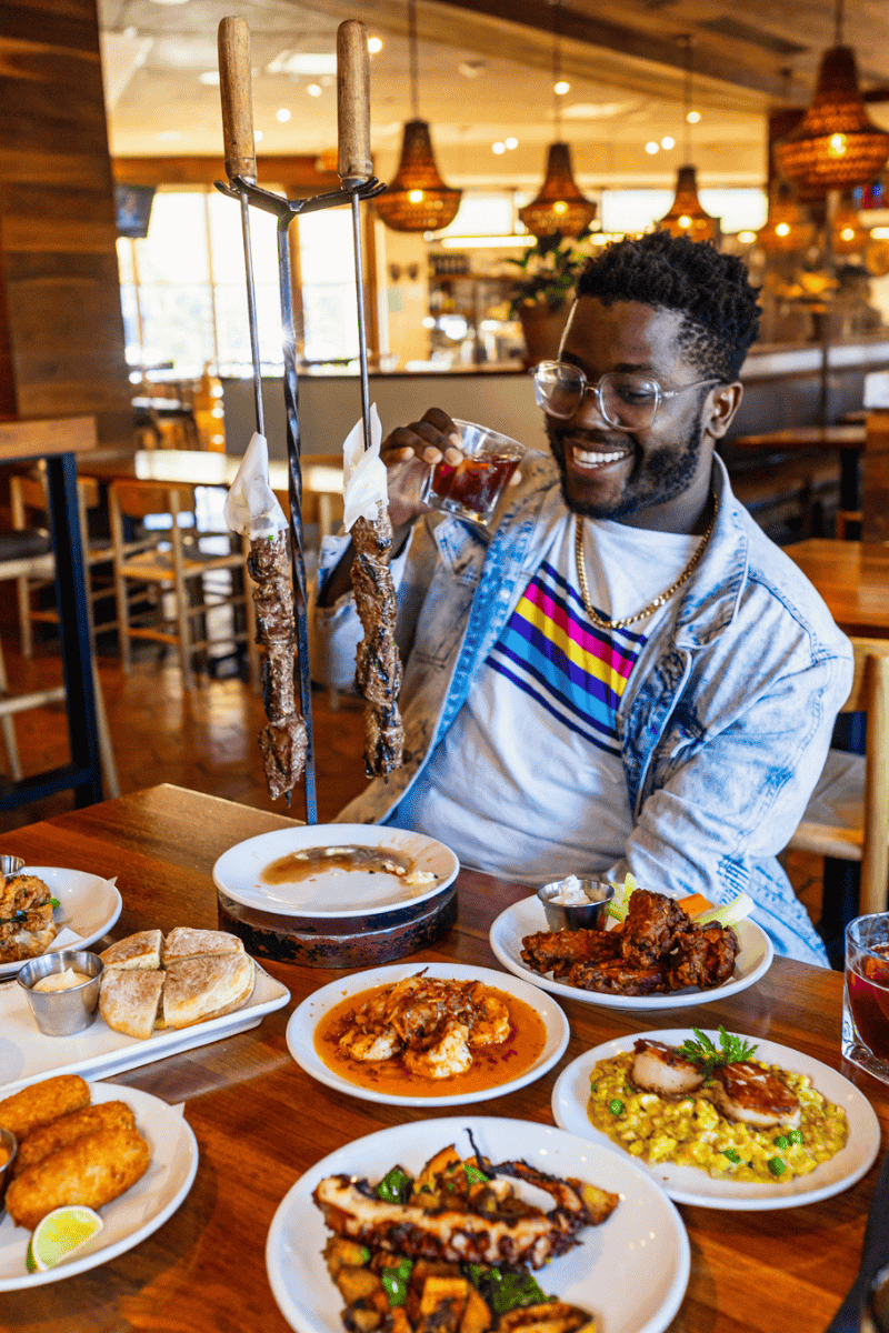 A man sitting at a table with plates of food