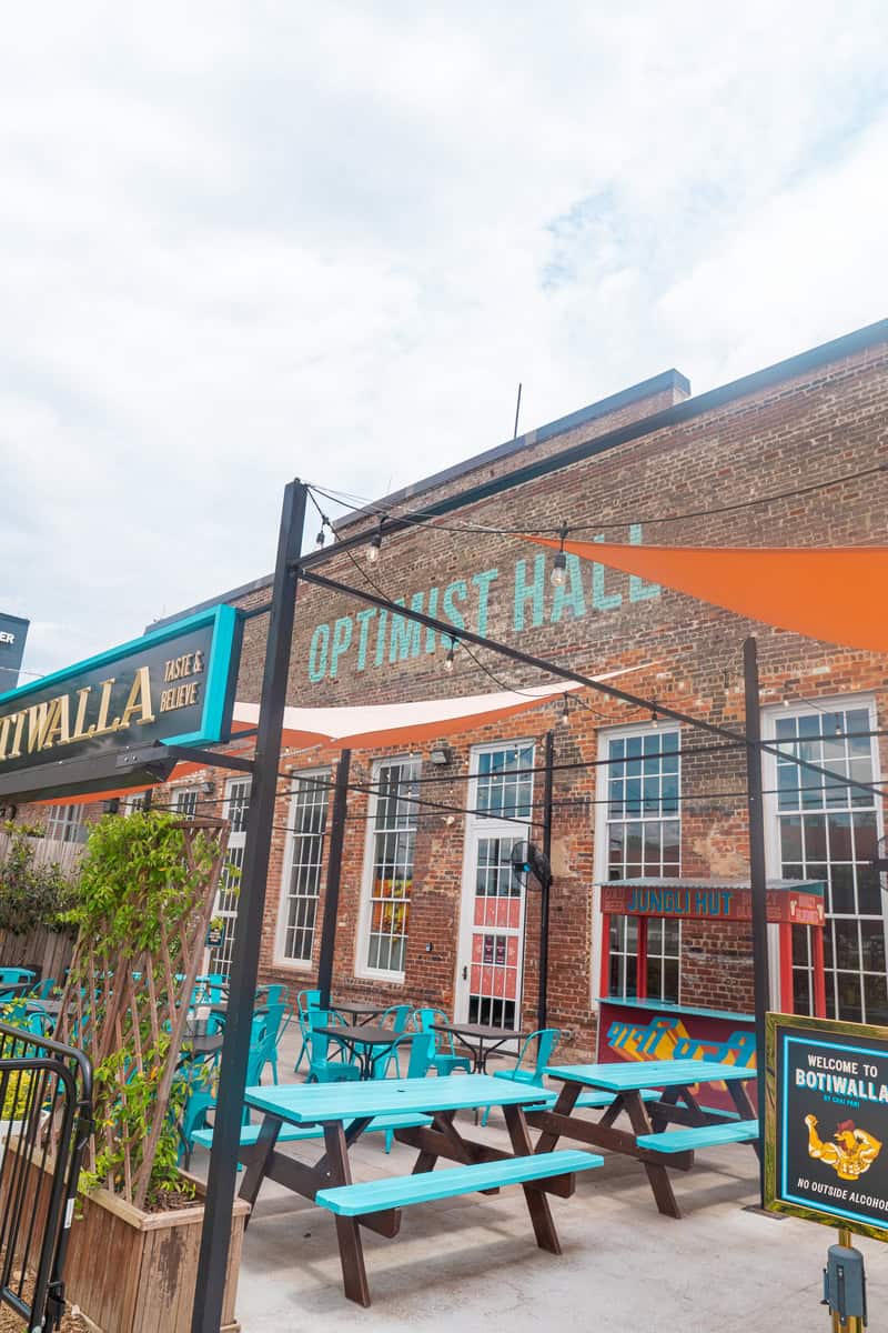 a building with blue tables and chairs