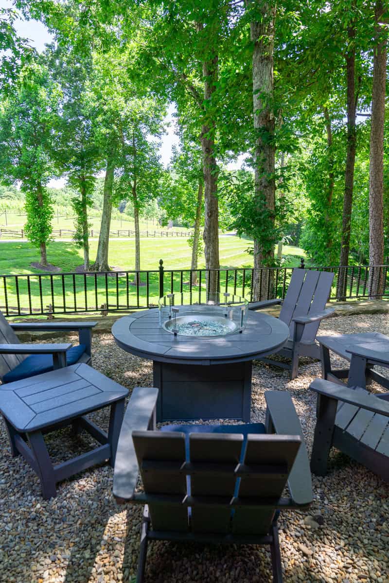 a table and chairs around a fire pit