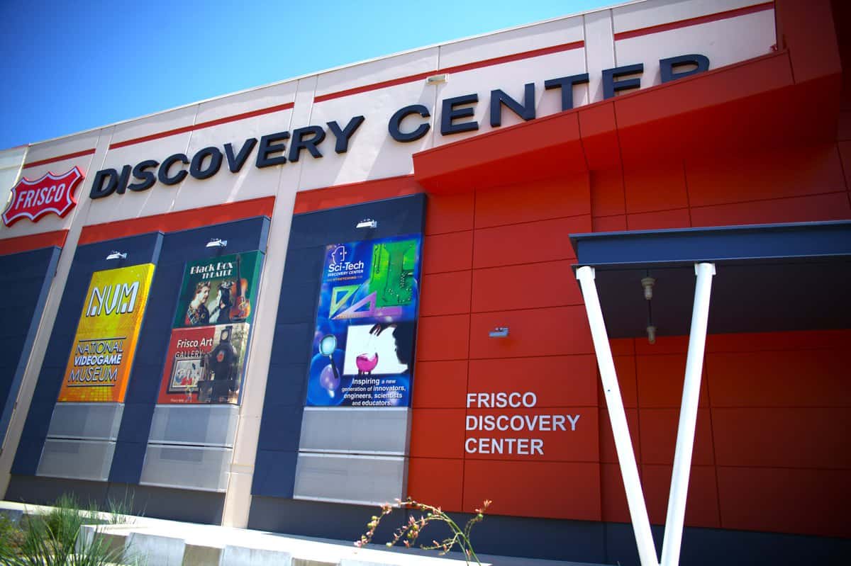 Facade of Frisco Discovery Center with colorful banners