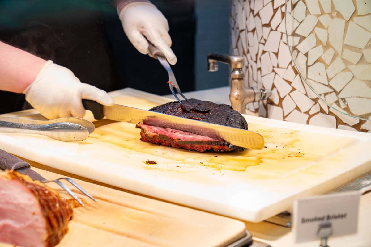 a person cutting a piece of meat