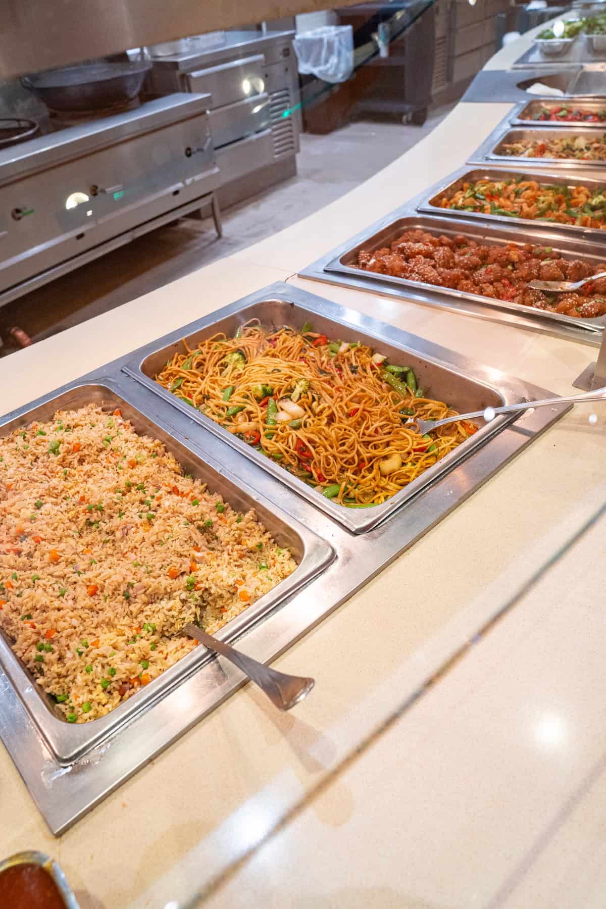 a row of metal trays with food in them